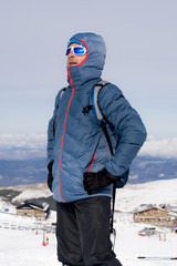 Fototapeta na wymiar man posing after peak summit trekking achievement in snow mountain on winter landscape