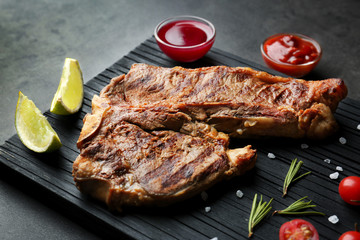 Composition of tasty steak and ingredients on kitchen table