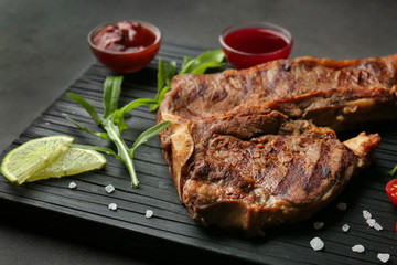 Composition of tasty steak and ingredients on kitchen table