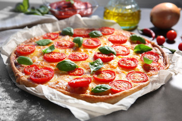 Delicious pizza on kitchen table