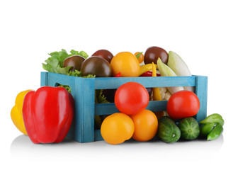 Group of fresh vegetables in wooden box on white background