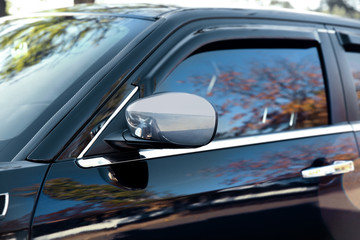Obraz na płótnie Canvas Mirror of luxury black car, closeup
