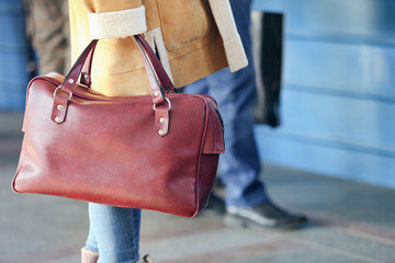 Woman at the railway station with bag