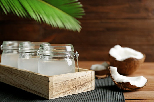 Set of mason jars with coconut water on dark bamboo mat