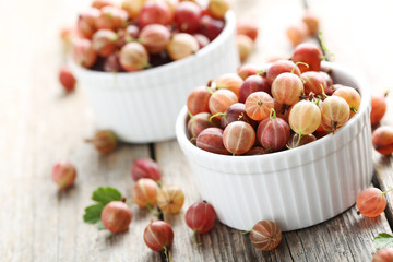 Gooseberries fruit on a grey wooden table