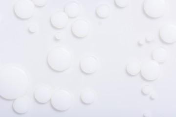 Abstract background with white paint drops in liquid