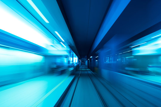 Underground subway tunnel blurred in speed motion and blue toned