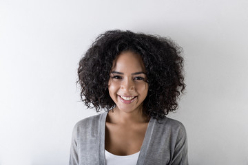 Portrait of an attractive woman smiling against white background