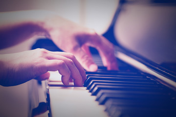 Scene of pianist hands from beside angle playing piano