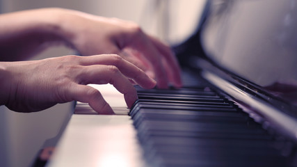 Scene of pianist hands from beside angle playing piano, Selective focus.