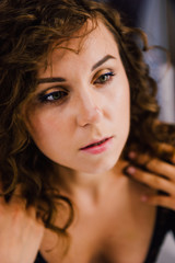 Sexy and beautiful woman wearing black lace body lingerie with curly hair