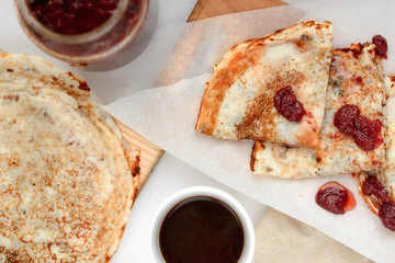 pancakes with strawberry jam and black coffee