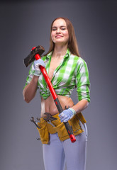 Female worker in overalls holding an axe