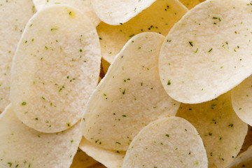 Close up potato chips on wood top view background.