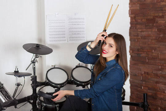 Woman drummer practicing  at home