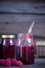 Homemade jam with raspberry on the wooden table