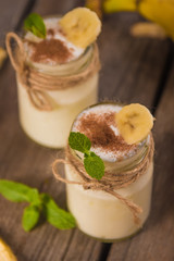 Organic homemade sweet milk dessert with banana, cinnamon and mi