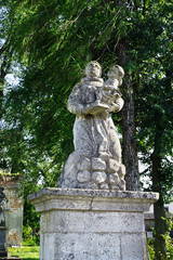 Fototapeta na wymiar statue of a saint near the Catholic Church of Exaltation of the Holy. Joseph, the 18th century in Ukraine