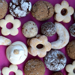 Various cookies on pink background. Top view. 