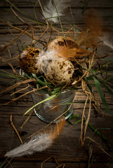 Rustic still life with eggs in vintage metal bucket on plank background for easter