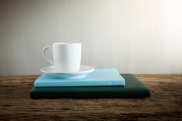 coffee cup and notebook on wooden table