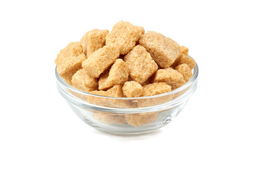 Bowl of brown cane sugar cubes on white