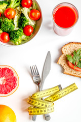 concept slimming diet fresh vegetables on white background top view