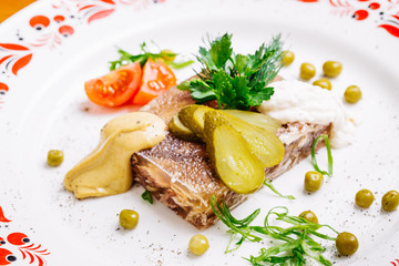 Jellied pork and beef with dill and parsley on the plate