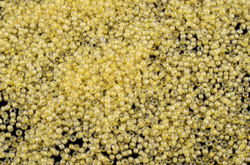 Yellow glass beads background - closeup beads texture
