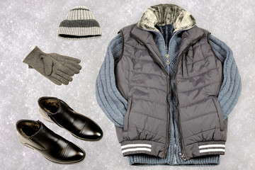 Men's winter clothing on the background of snow