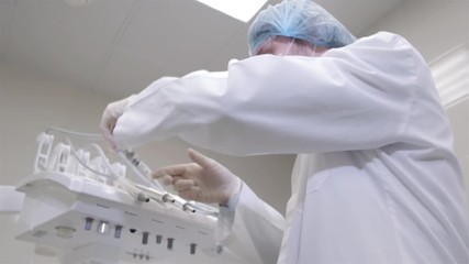 Dentist holding dental tools looking at camera. Personal or patient point of view, POV. He is a man on his late twenties, wearing dental magnifying glasses and holding drill.