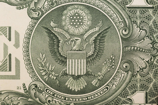 A one dollar bill close up, showing the eagle on the great seal of the United States