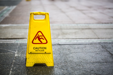 Sign showing warning of caution wet floor outdoors