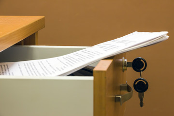 Business papers and documents are in a desk drawer
