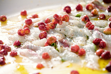 Sashimi with wild strawberries close-up