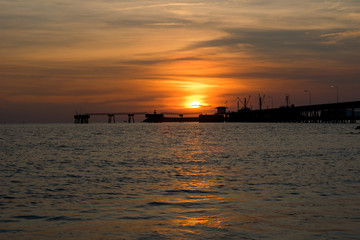 Fototapeta na wymiar People walk ocean beach sunset