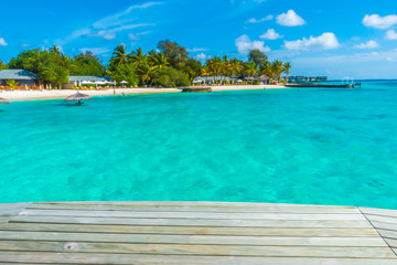 Wooden planks in tropical Maldives island and beauty of the sea