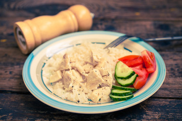 chicken fillet with rice and vegetables, selective focus, the image is tinted