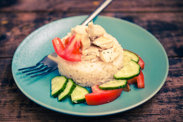 chicken fillet with rice and vegetables, selective focus, the image is tinted