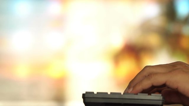 Man typing on computer keyboard in slow motion
