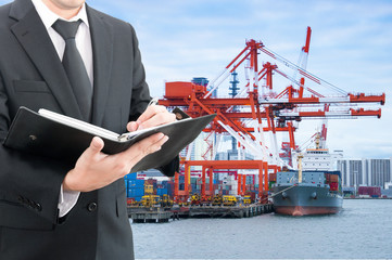 Businessman writing notebook with commercial delivery cargo cont
