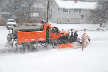 snowplow removing snow in the street after blizzard