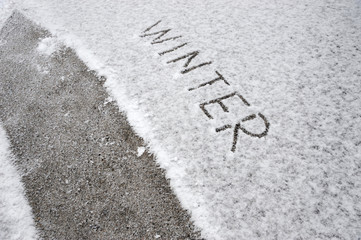 hand written winter text on snow background