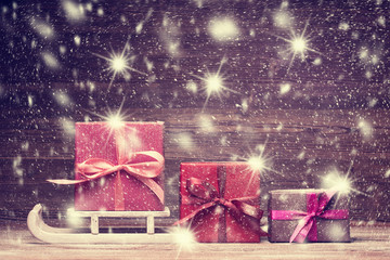 Santa's sledge and set of gift boxes over snowy background