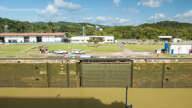 Panama Canal Side View of an Empty Lock on a Perfect Day featuring the Panamanian Flag and a Tropical Jungle Background