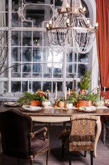 Obraz na płótnie Canvas Dining table decorated for Christmas and evergreen centerpiece