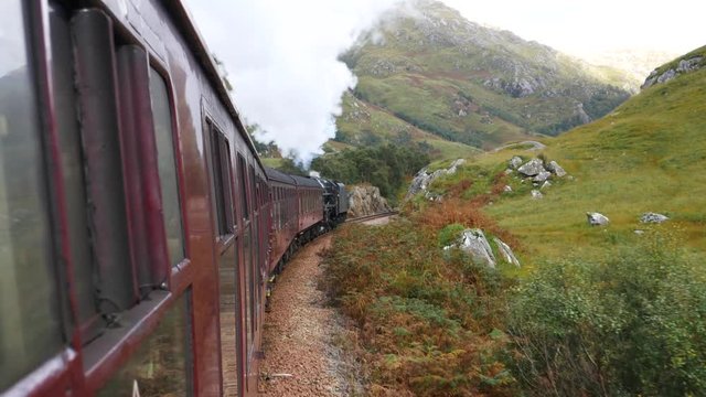 Glenfinnan Railway Viaduct in Scotland with the Jacobite steam train in Scotland, UK
