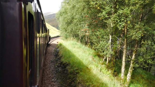 Glenfinnan Railway Viaduct in Scotland with the Jacobite steam train in Scotland, UK
