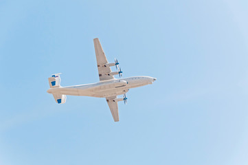 Antonov An-22 Antei (Antaeus, Cock) the world's largest turboprop-powered aircraft flies on blue sky background