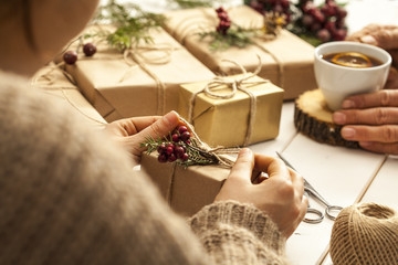 People hands wrap gift boxes